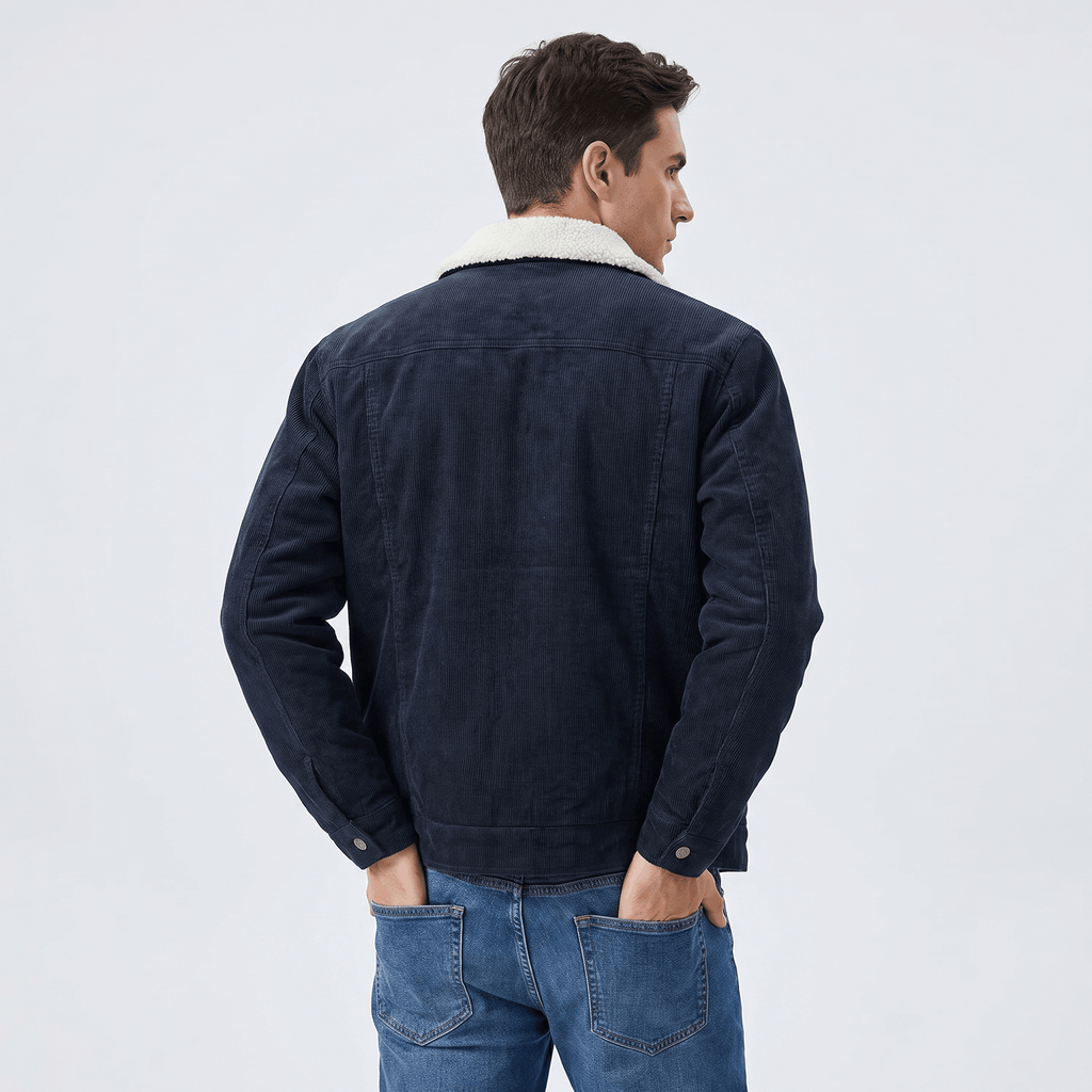 Navy blue corduroy jacket with a white sherpa turn-down collar, worn over blue jeans against a neutral background.