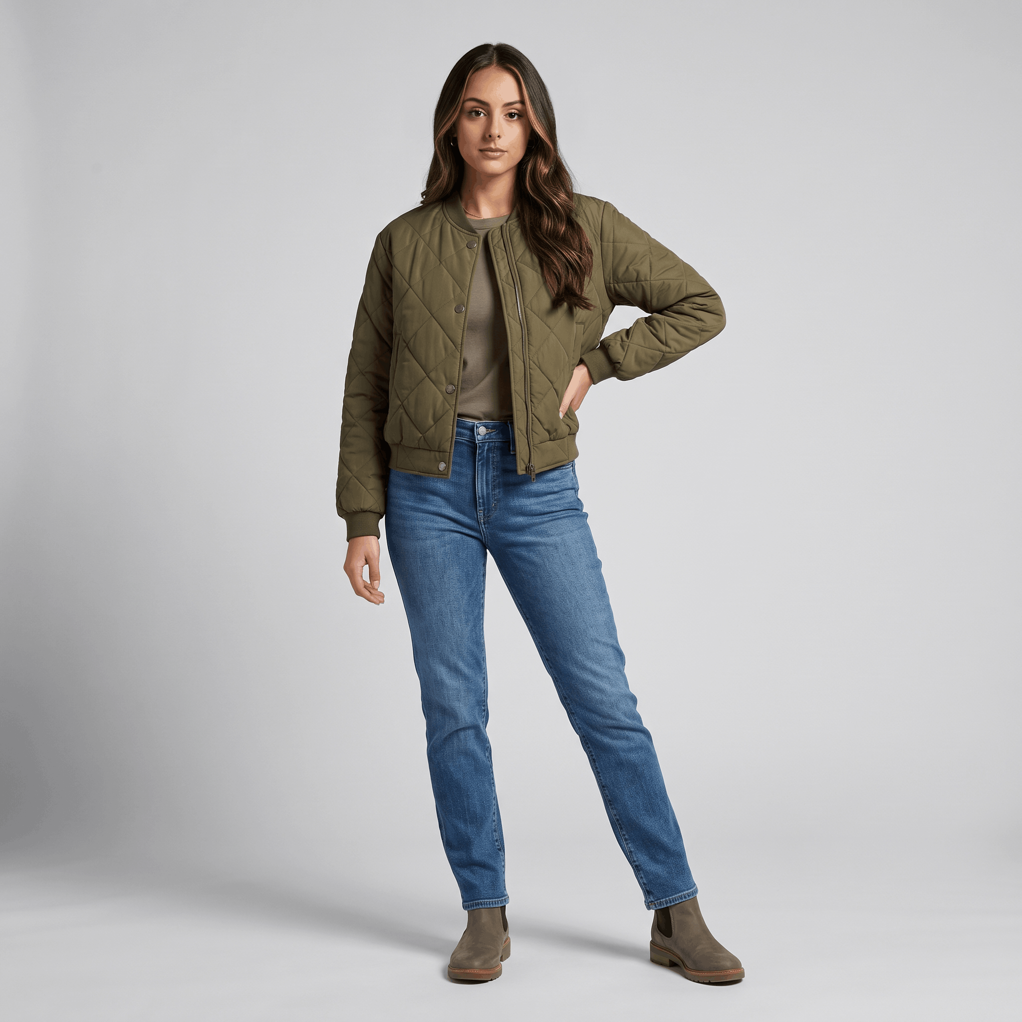 Female model wearing the olive green quilted jacket with blue jeans.