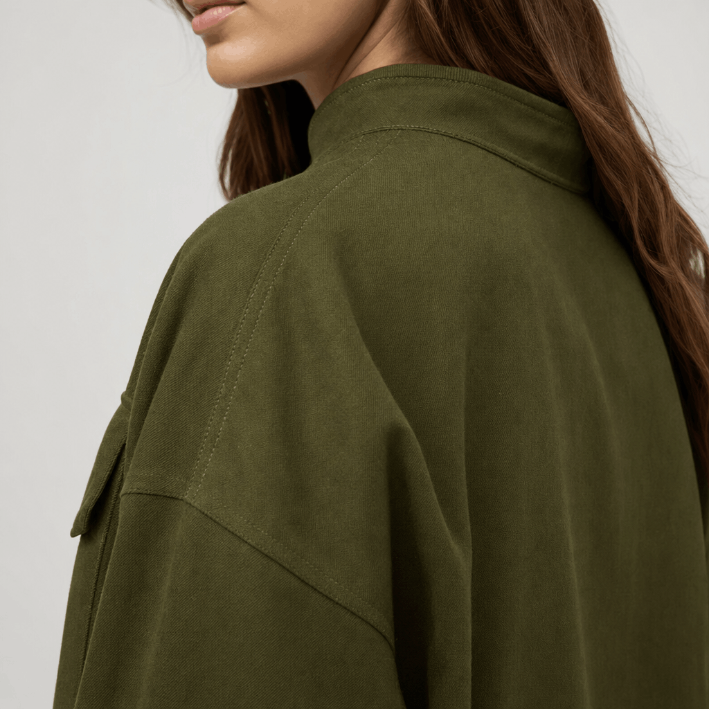 Close-up back view of the olive green cropped jacket, showing the collar and shoulder seams.