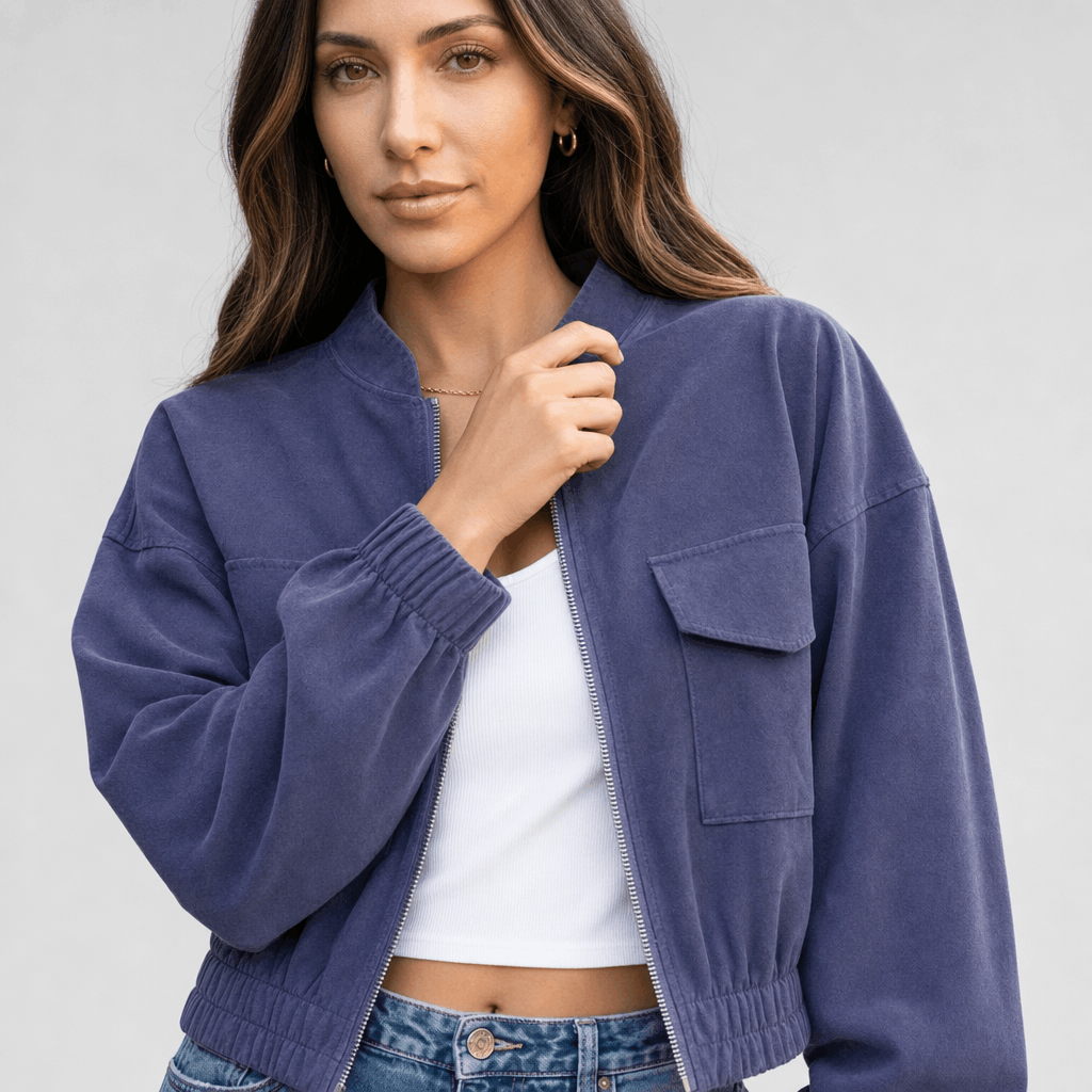 Female model wearing the blue cropped jacket, highlighting the stand collar, front buttons, and chest pocket.
