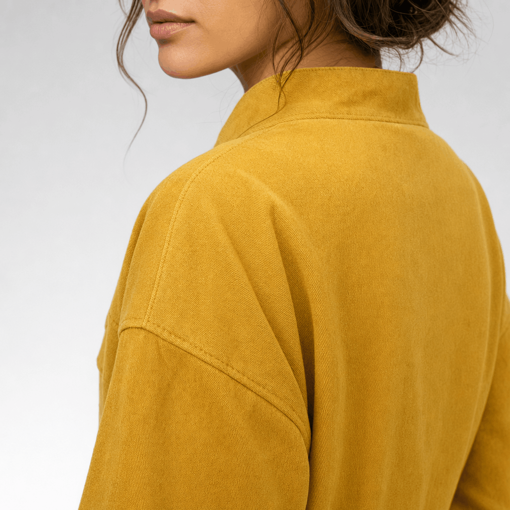 Close-up back view of the mustard yellow jacket, highlighting the stand collar and shoulder seams.