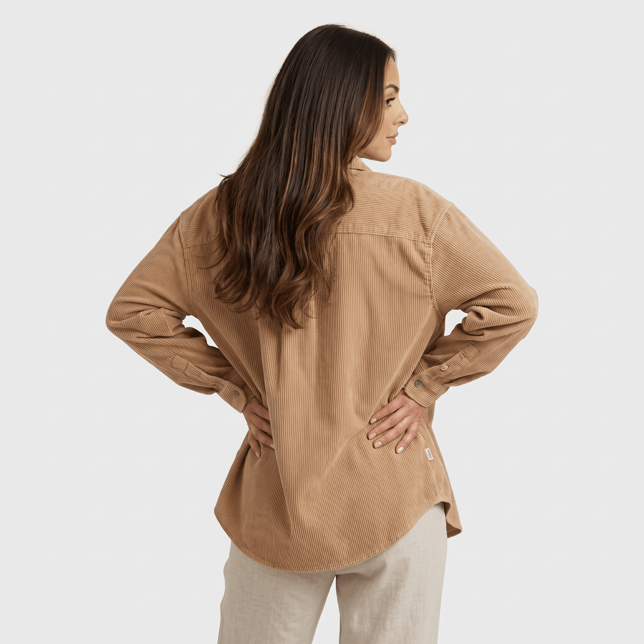 Beige fine wale corduroy button-down shirt with a relaxed fit, point collar, and long sleeves on a model.