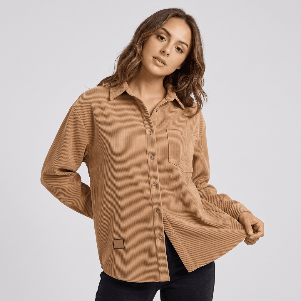 Beige fine wale corduroy button-down shirt with a relaxed fit, point collar, and long sleeves on a model.