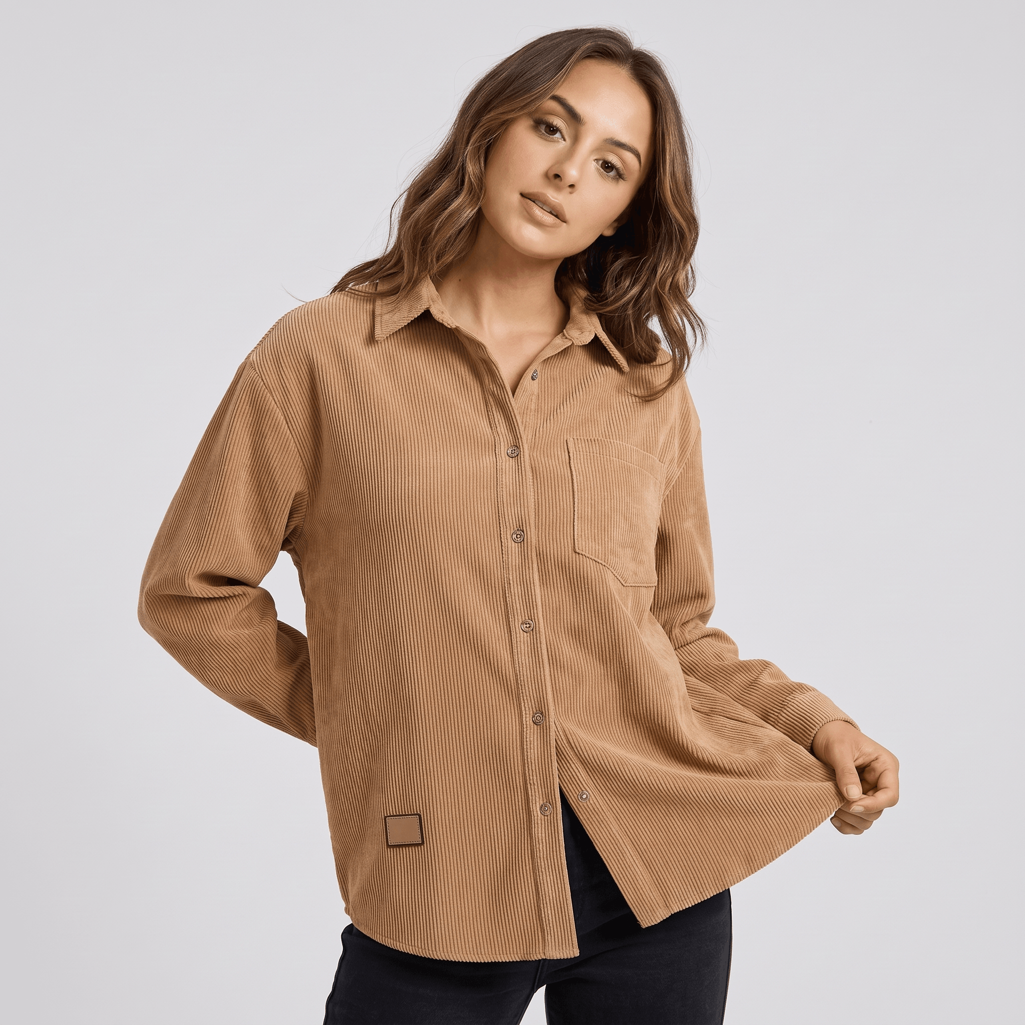 Beige fine wale corduroy button-down shirt with a relaxed fit, point collar, and long sleeves on a model.