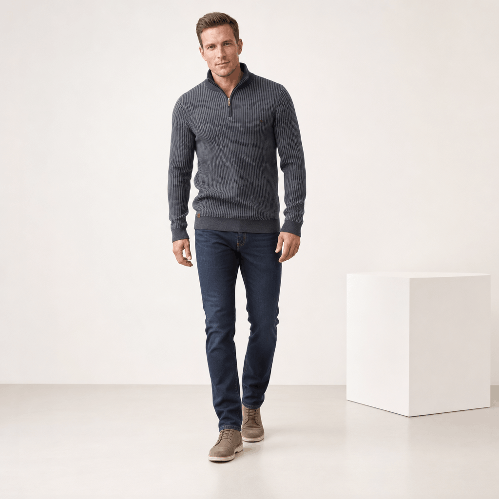 Full-body view of the man wearing the medium gray half-zip sweater with dark pants.