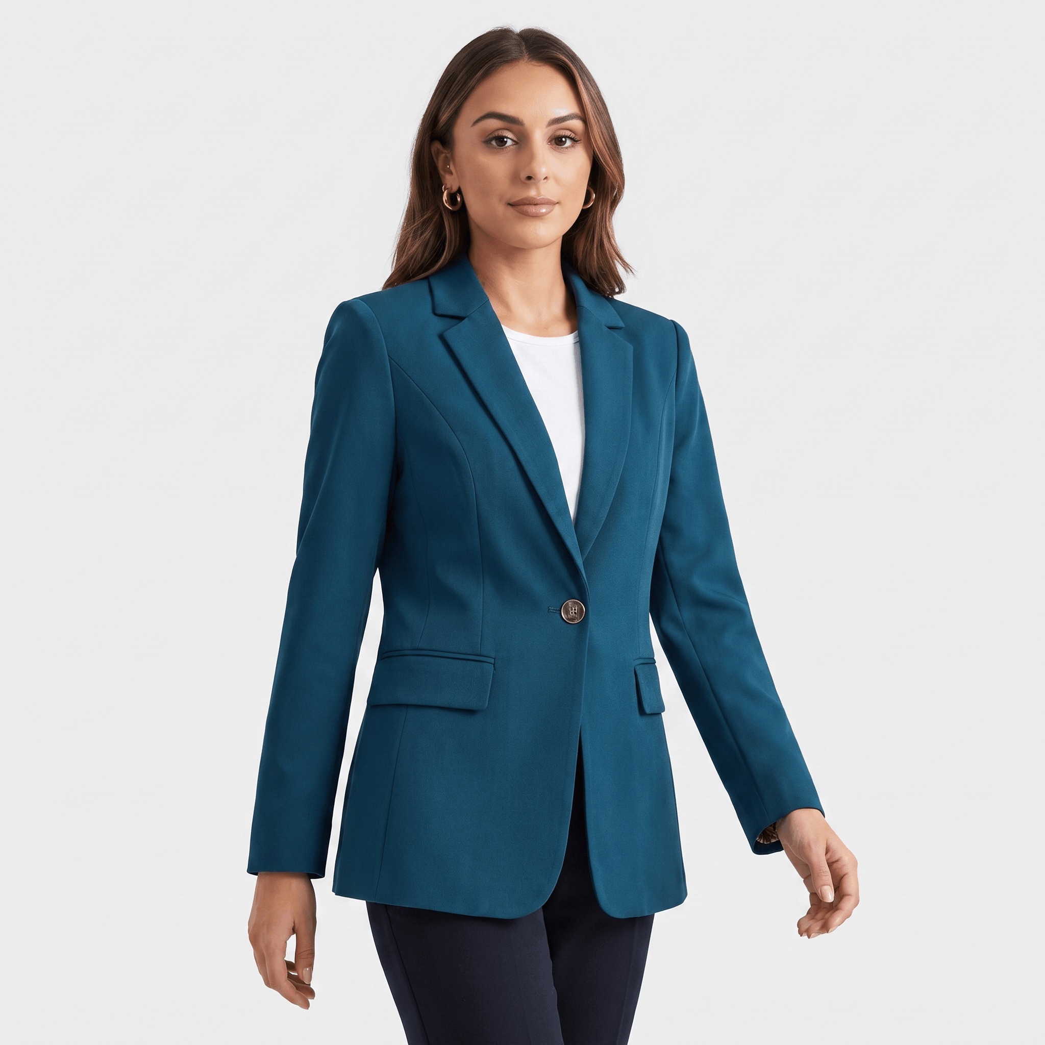 Female model wearing a teal blue tailored blazer with notched lapels, a single-button closure, and flap pockets.