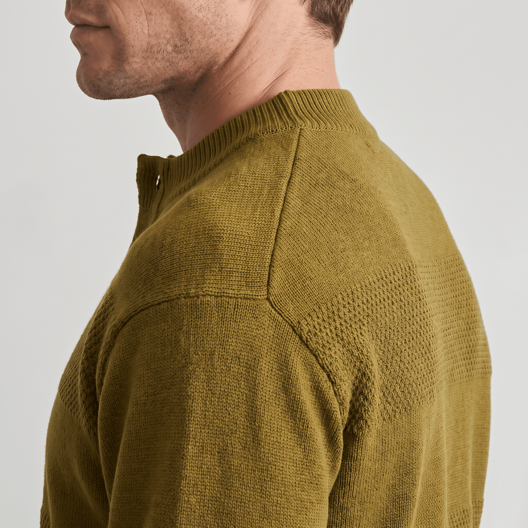 Olive green chunky knit henley sweater featuring alternating smooth and raised textured stripes and a ribbed crew neckline.