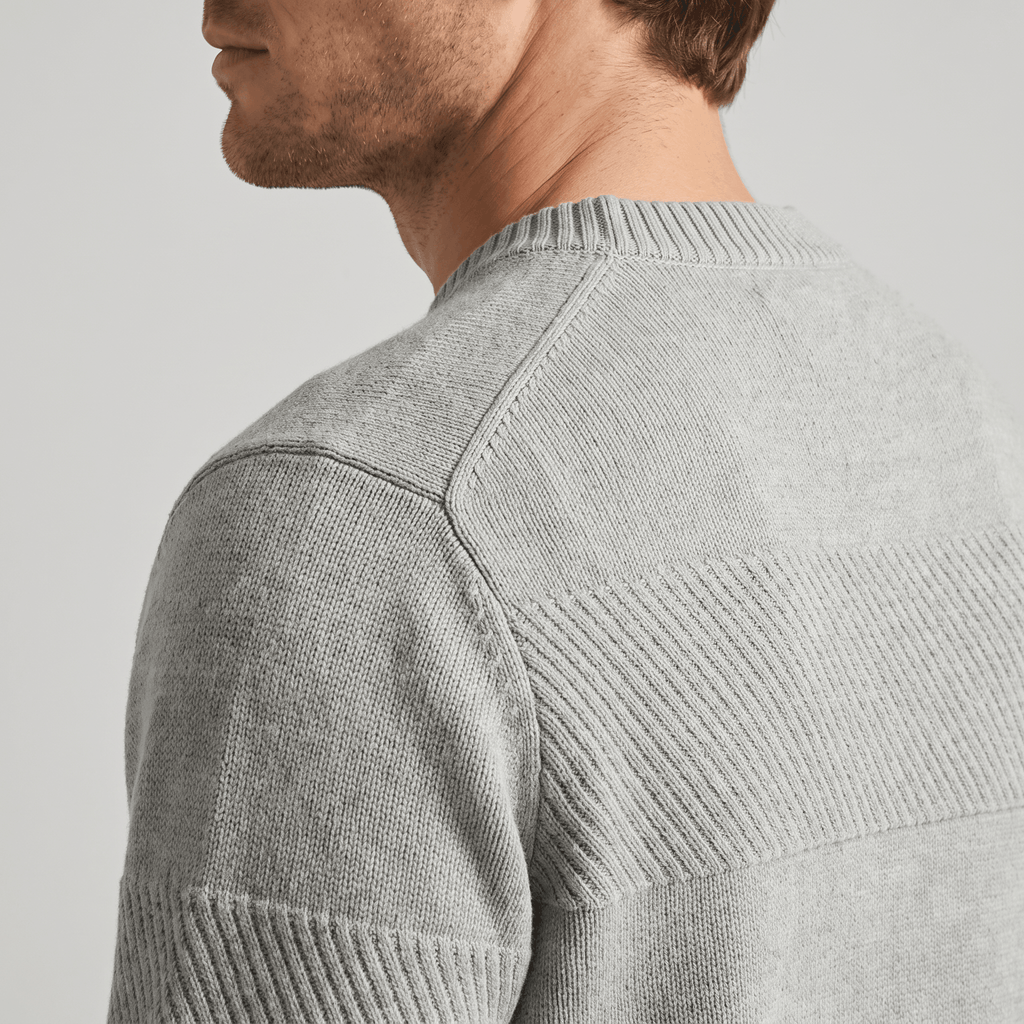 Grey chunky knit henley sweater featuring alternating smooth and raised textured stripes with a ribbed crew neckline.