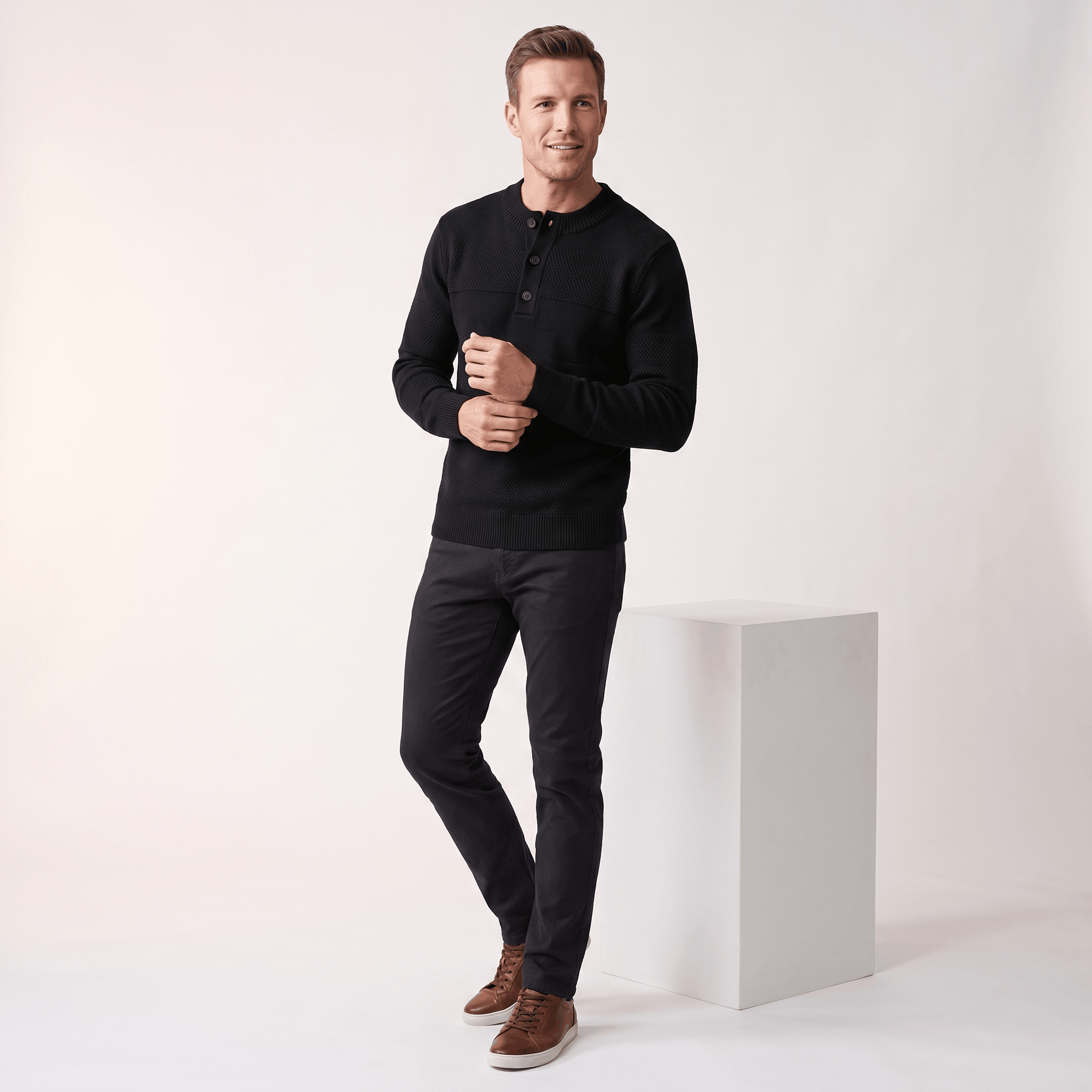 Black chunky knit henley sweater featuring textured horizontal stripes, a three-button placket, and ribbed trim details.