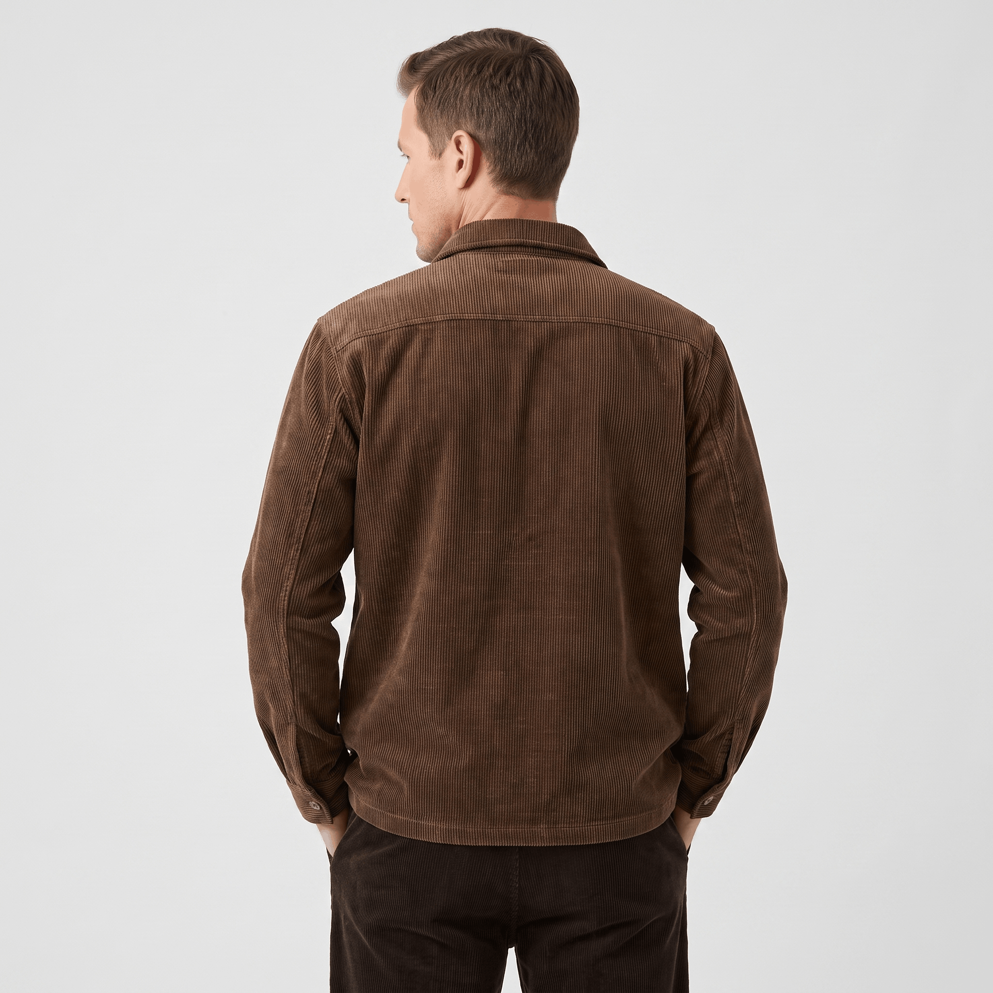Brown corduroy shirt jacket with a relaxed fit, featuring a soft washed texture and structured collar, worn from behind.