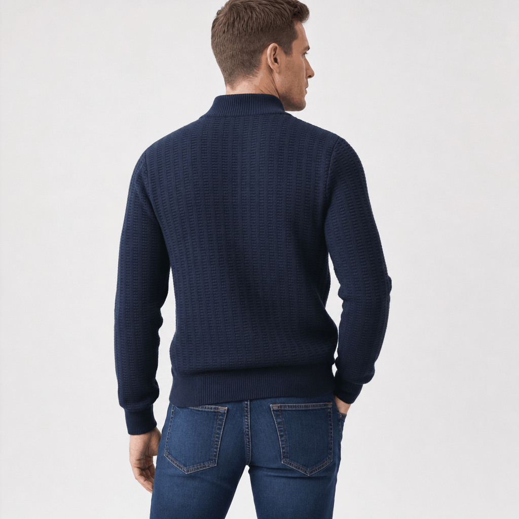 Back view of the man wearing the navy blue textured half-zip sweater with jeans.