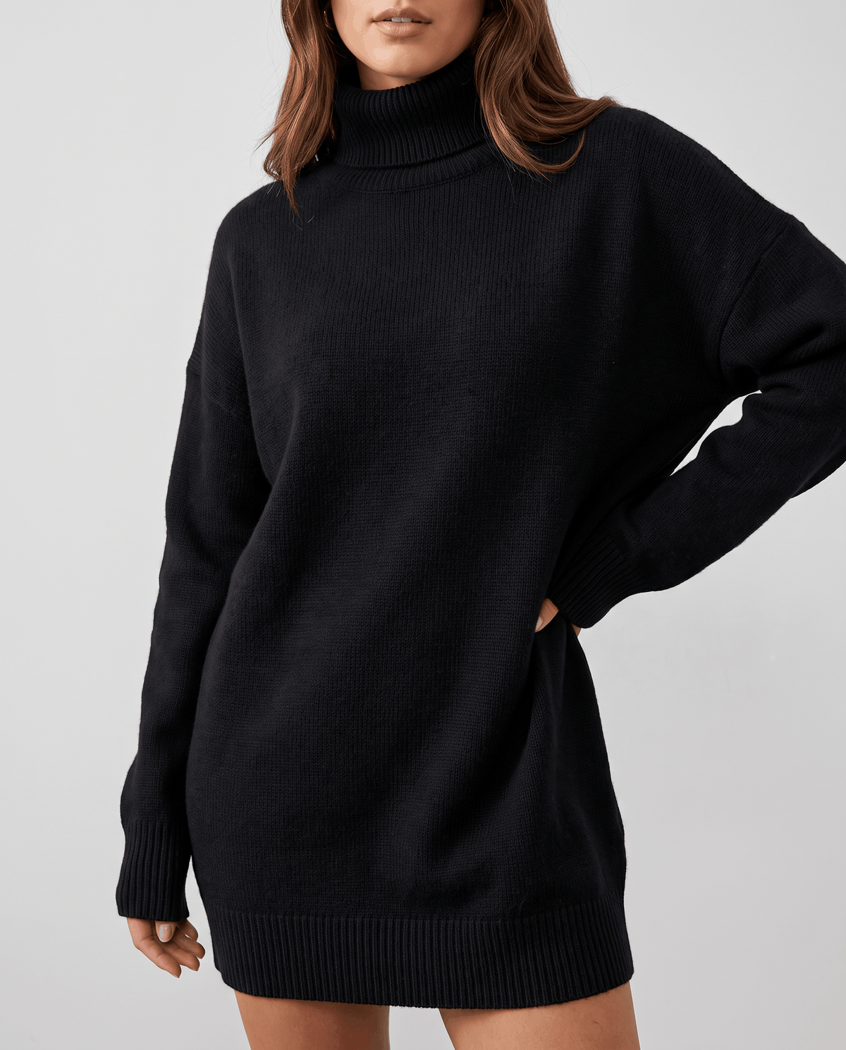 Black Oversized Longline Sweater worn by a female model, featuring a slouchy oversized fit, high turtleneck collar, long sleeves, and extended hem.