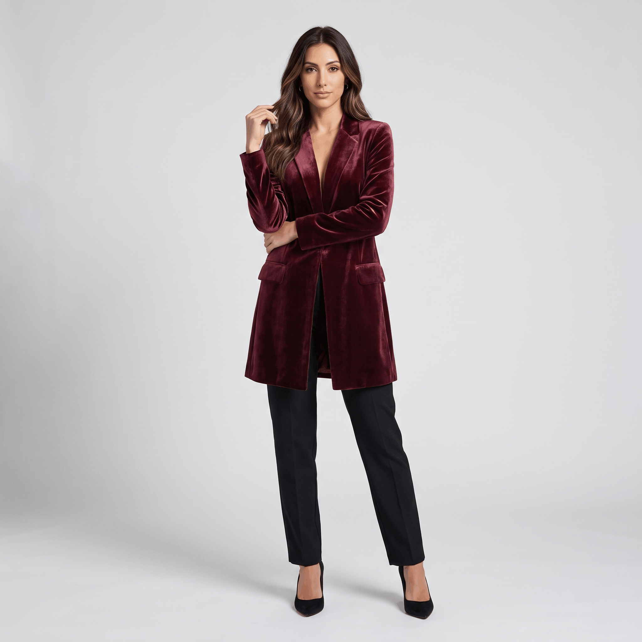 Female model wearing the burgundy velvet blazer coat with black trousers and heels.
