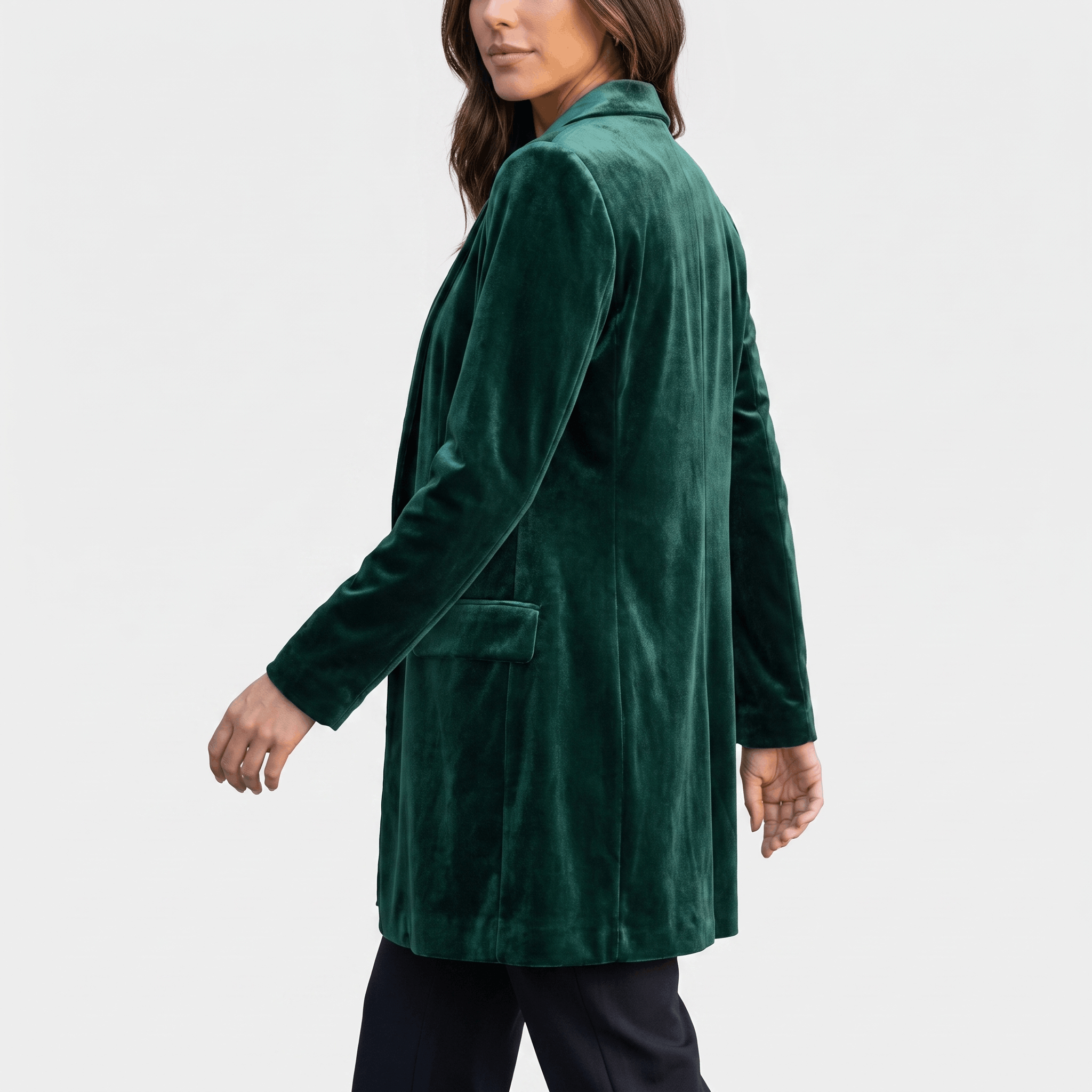 Female model wearing the dark green velvet blazer coat, showing the back and fitted silhouette.