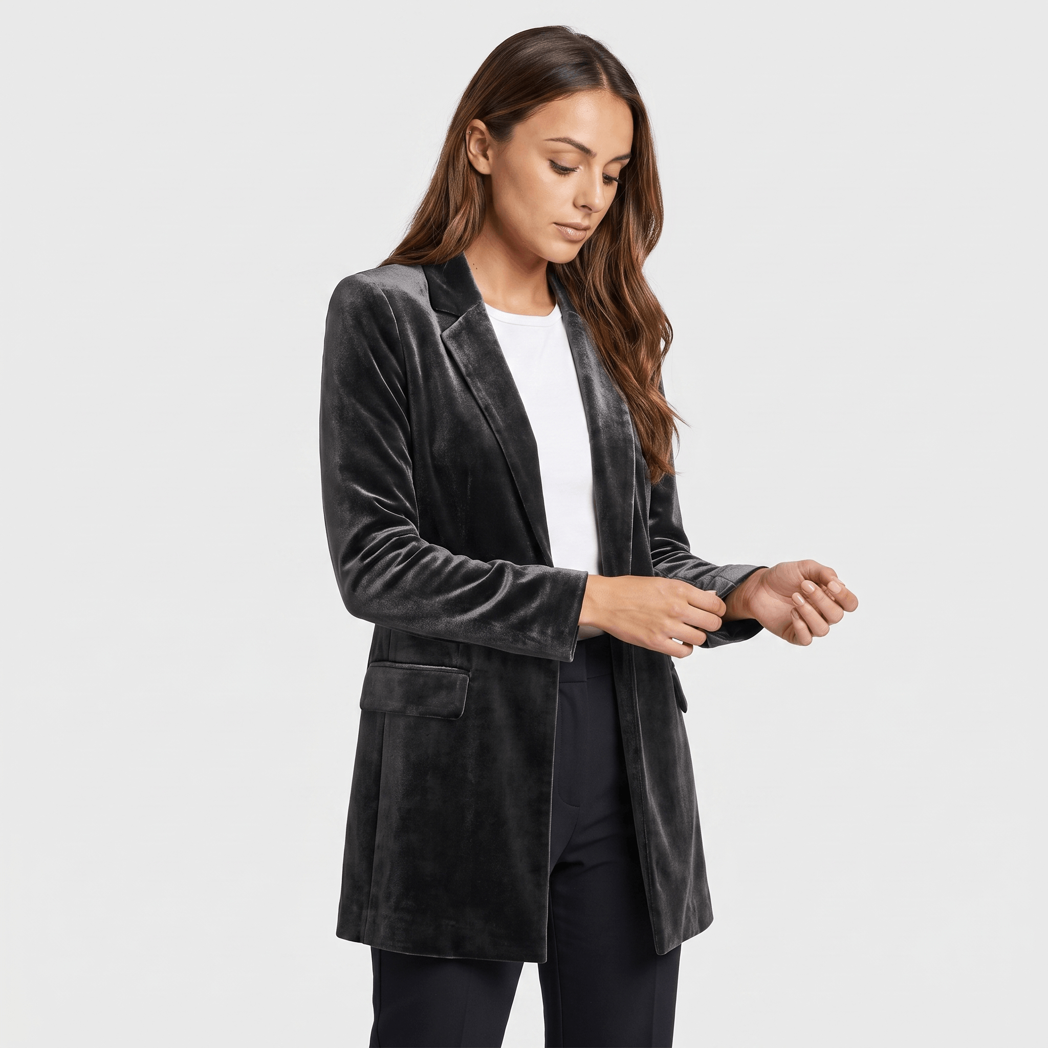 Female model wearing a black velvet long blazer coat with a notched lapel and single-button closure.