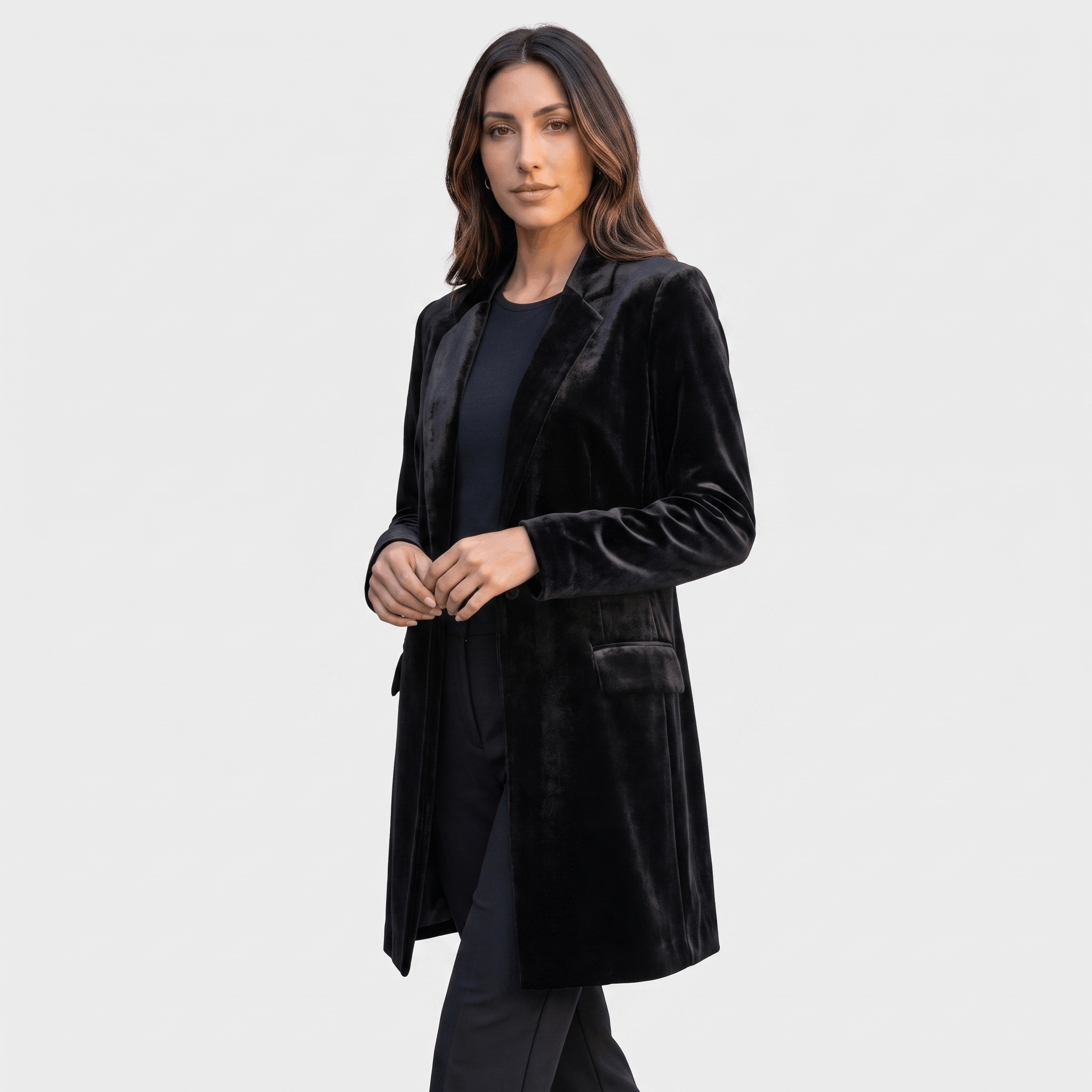 Female model wearing the black velvet blazer coat with a fitted silhouette and long sleeves.