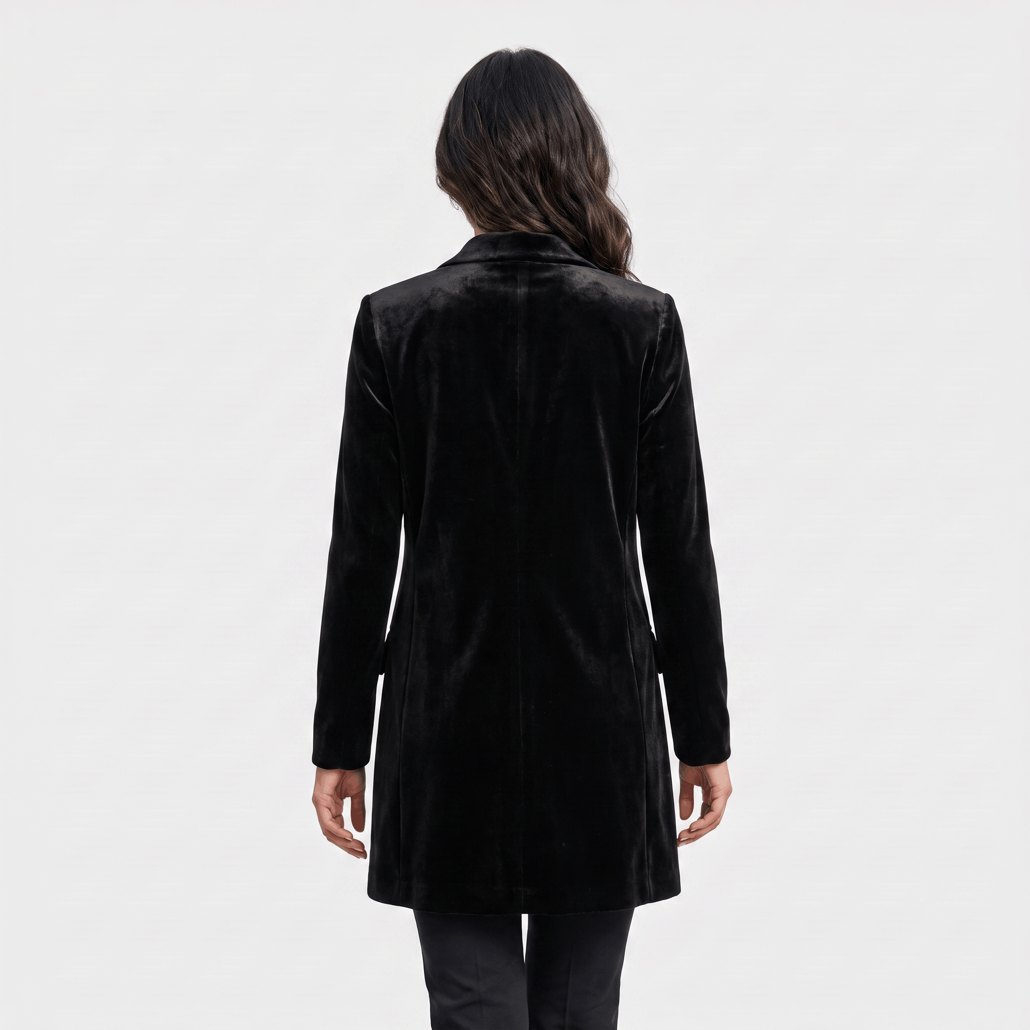 Female model wearing the black velvet blazer coat, showing the back and fitted shape.