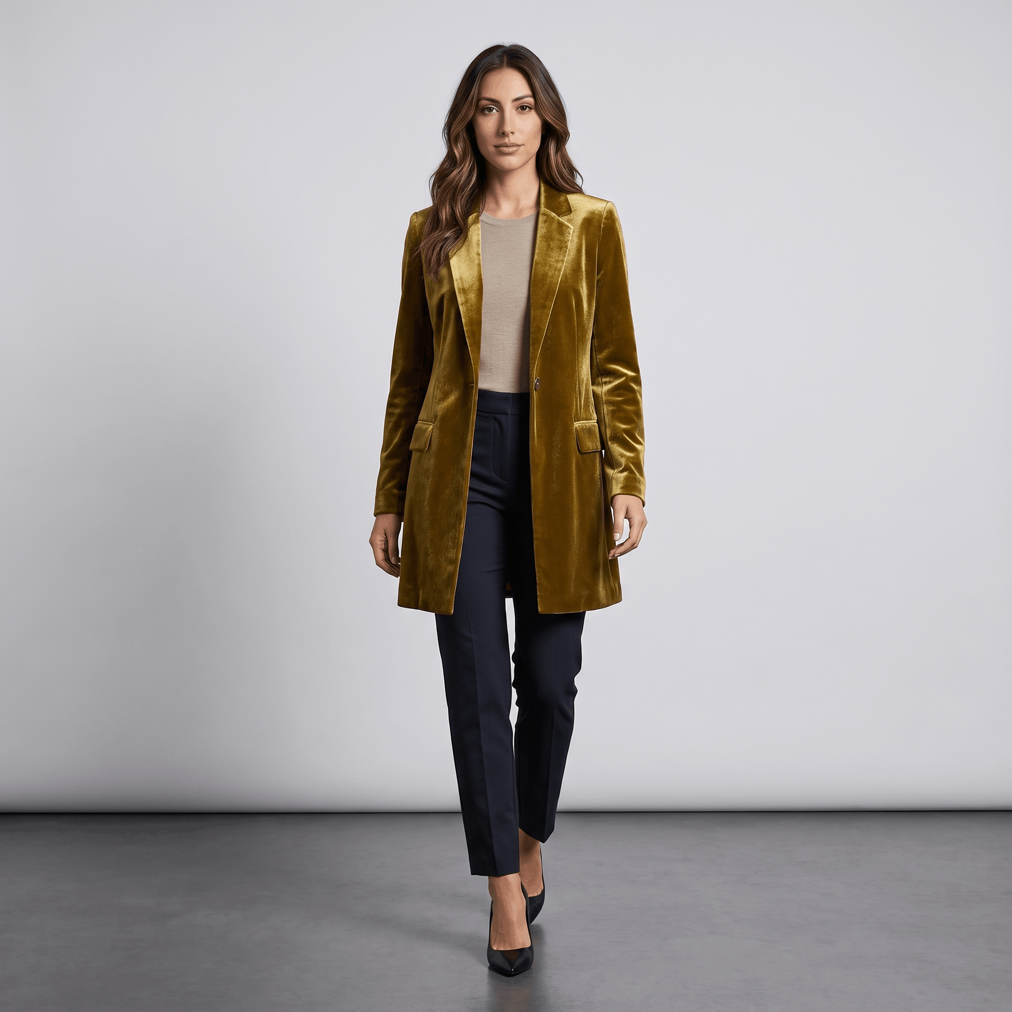 Female model wearing the mustard olive velvet blazer with dark trousers and heels.