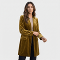 Female model wearing a mustard olive velvet blazer with notched lapels, a single-button closure, and front patch pockets, paired with dark trousers.
