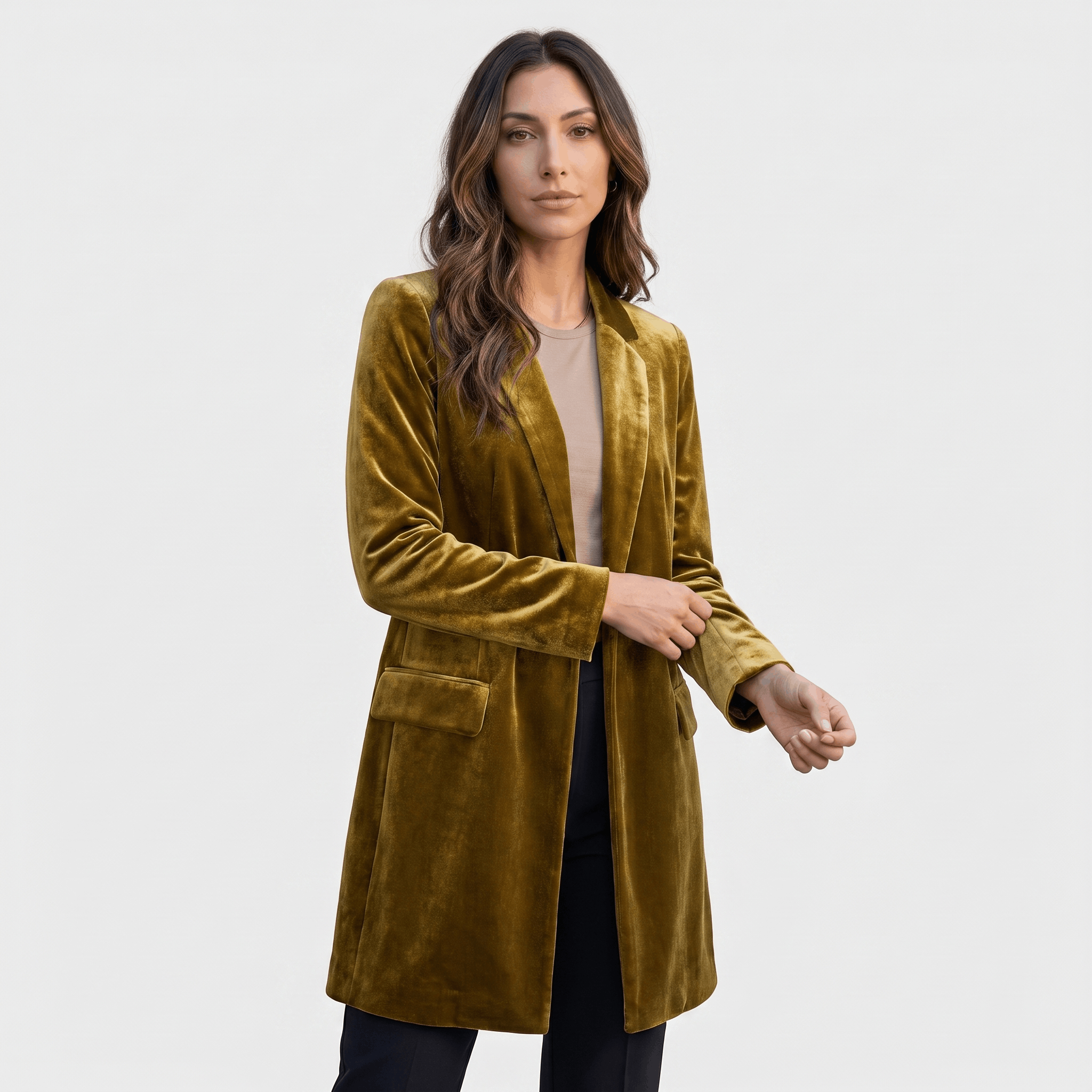 Female model wearing a mustard olive velvet blazer with notched lapels, a single-button closure, and front patch pockets, paired with dark trousers.