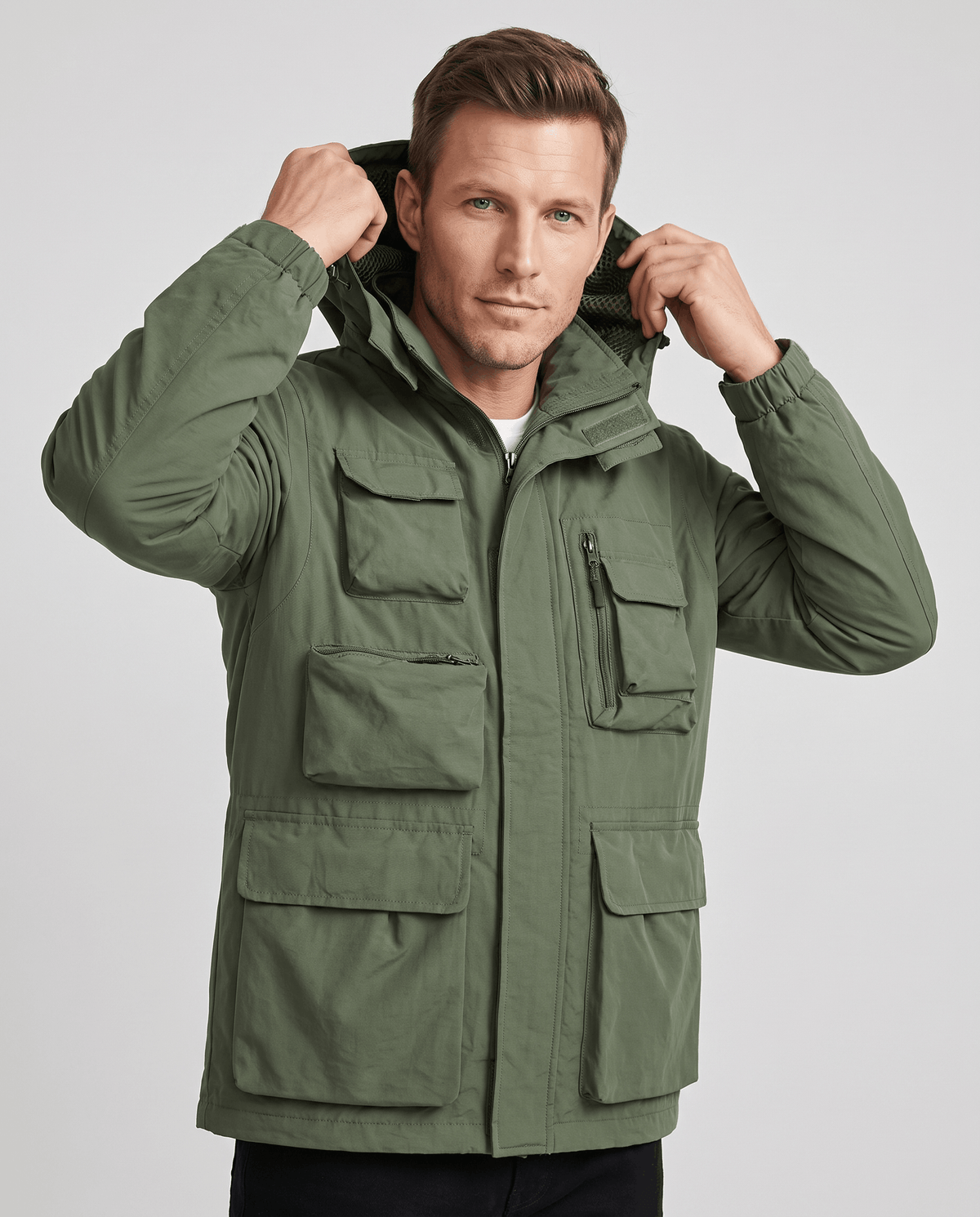 A man wearing a green parka jacket with warm padded lining, a hood, and multiple front pockets