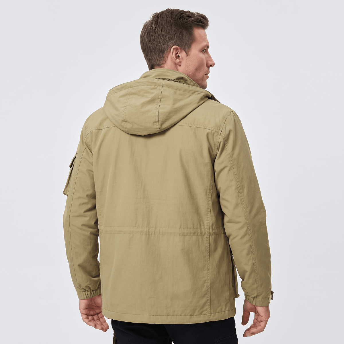 A man wearing a khaki hooded parka jacket with warm padded lining, shown from the back