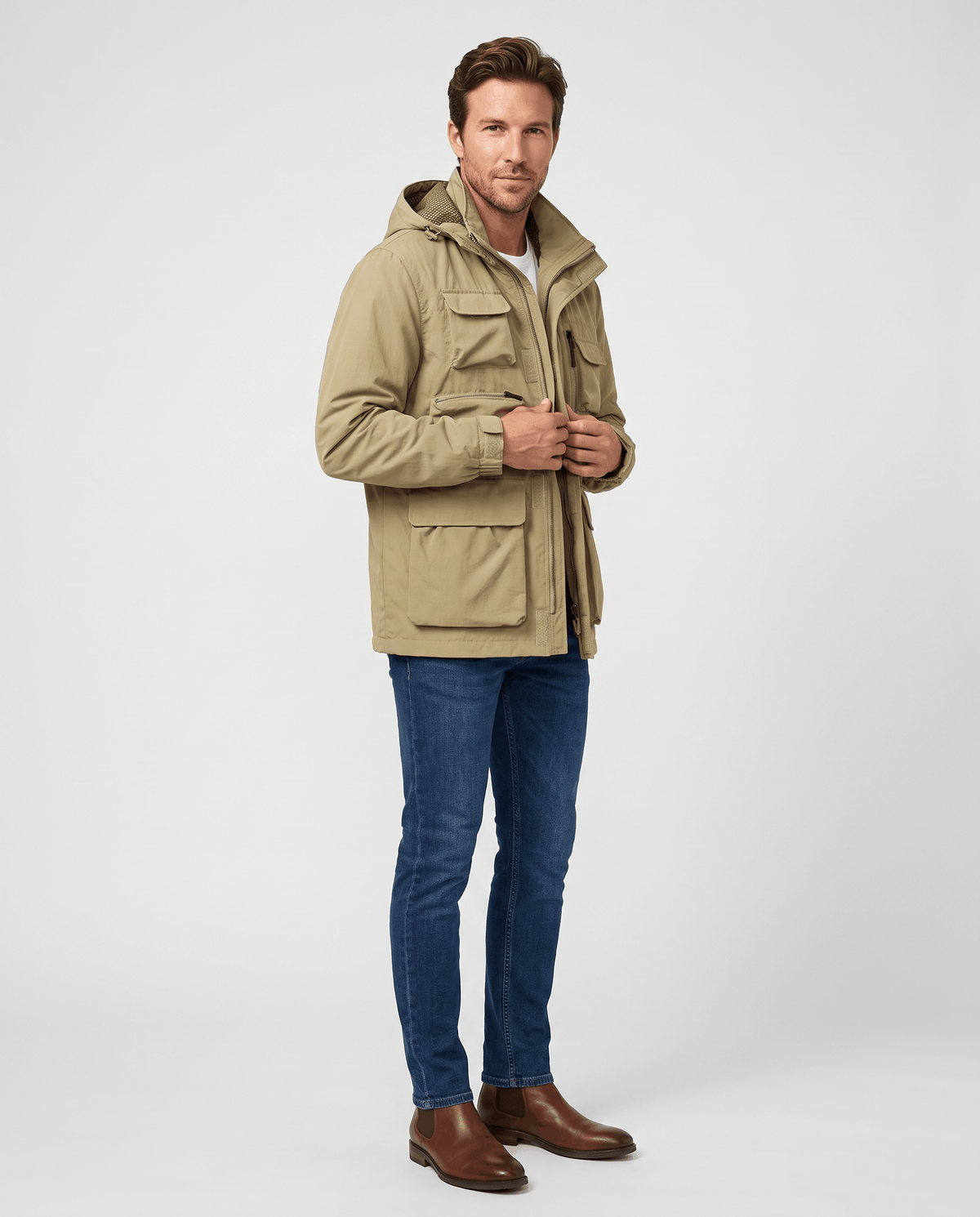 A man wearing a khaki hooded parka jacket with warm padded lining and multiple front pockets
