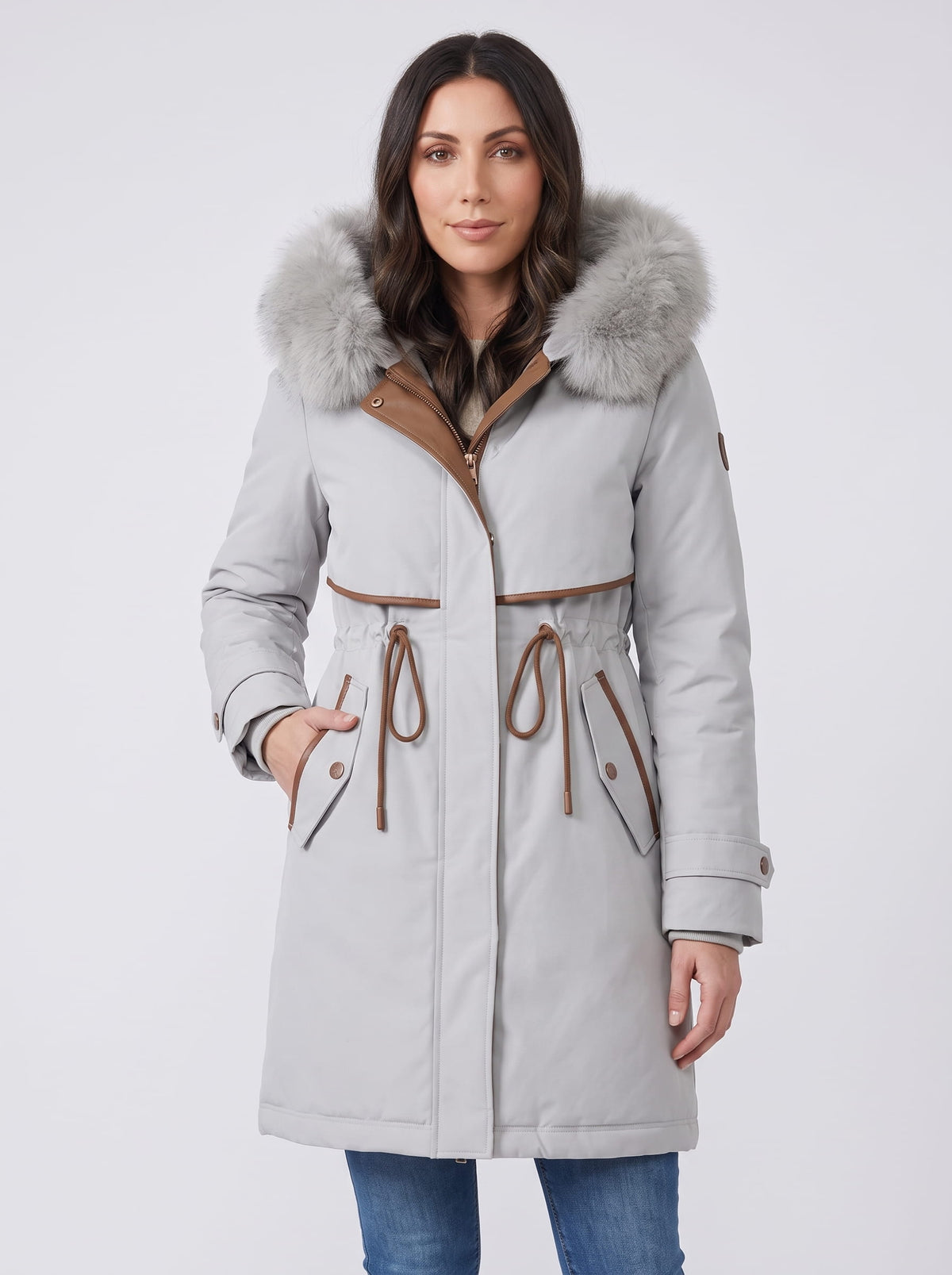Light gray plush hood trim winter parka with belted waist and front pockets worn by a female model
