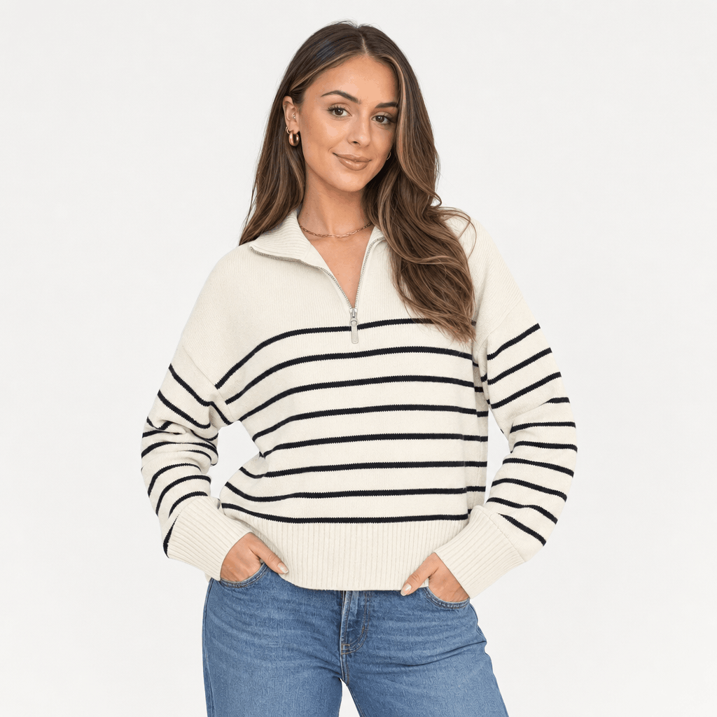 Female model wearing the cream and black striped quarter-zip sweater in a relaxed front-facing pose.