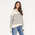 Female model wearing a cream quarter-zip sweater with thin black horizontal stripes, paired with blue jeans.