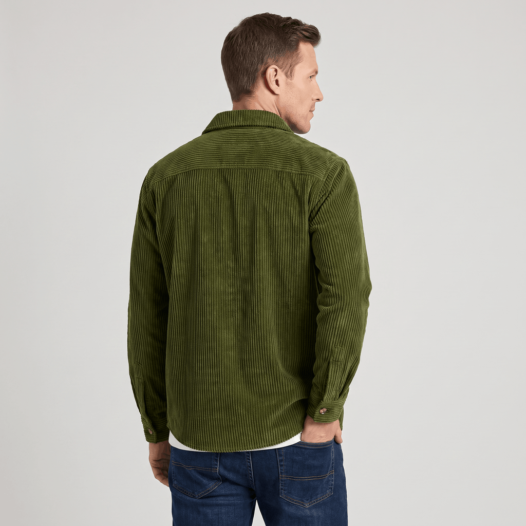 Olive green wide wale corduroy overshirt with a relaxed fit, worn over a white tee and blue jeans.
