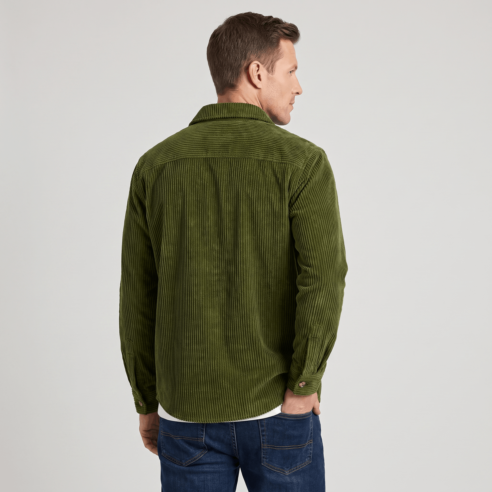 Olive green wide wale corduroy overshirt with a relaxed fit, worn over a white tee and blue jeans.