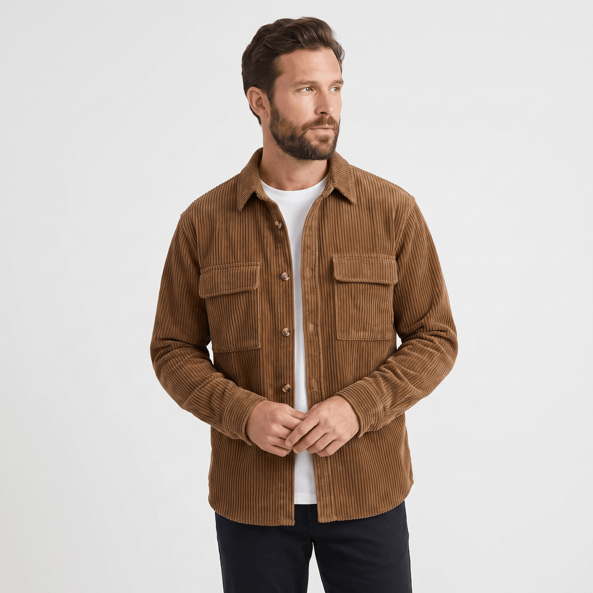 Brown wide wale corduroy overshirt with buttoned chest pockets, worn open over a white tee in a relaxed fit.