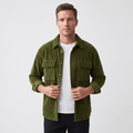 Olive green wide wale corduroy overshirt with flap chest pockets, worn open over a white tee in a relaxed fit.
