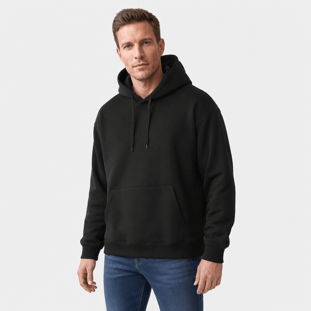 Male model wearing a black pullover hoodie with dark pants.