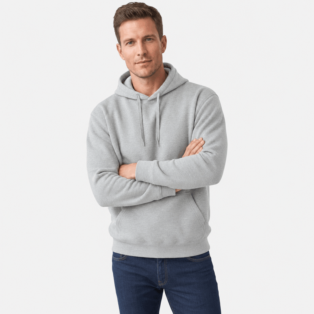 Male model wearing a light gray pullover hoodie with arms crossed.