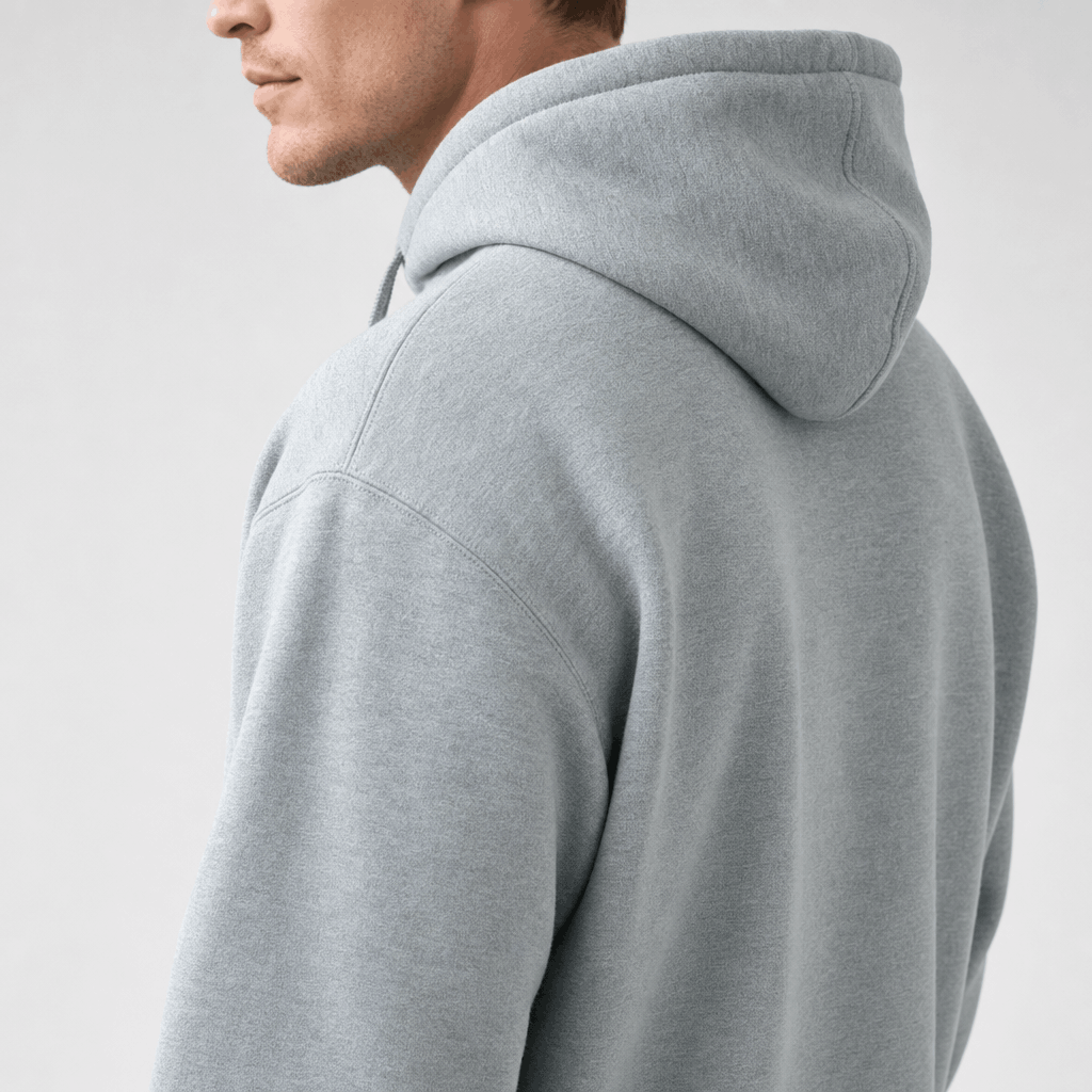 Close-up side and back view of the light gray hoodie, highlighting the hood and shoulder.