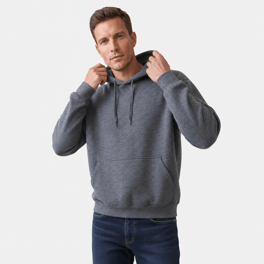 Male model wearing a charcoal gray pullover hoodie while adjusting the hood with both hands.