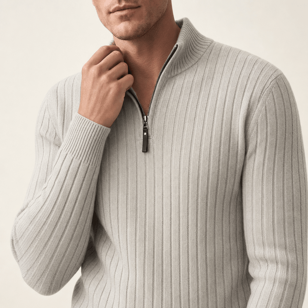 Close-up showing the half-zip neckline and vertical ribbed knit texture of the ivory sweater.