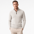 Man wearing an ivory ribbed half-zip sweater with beige pants, shown in a front-facing pose.