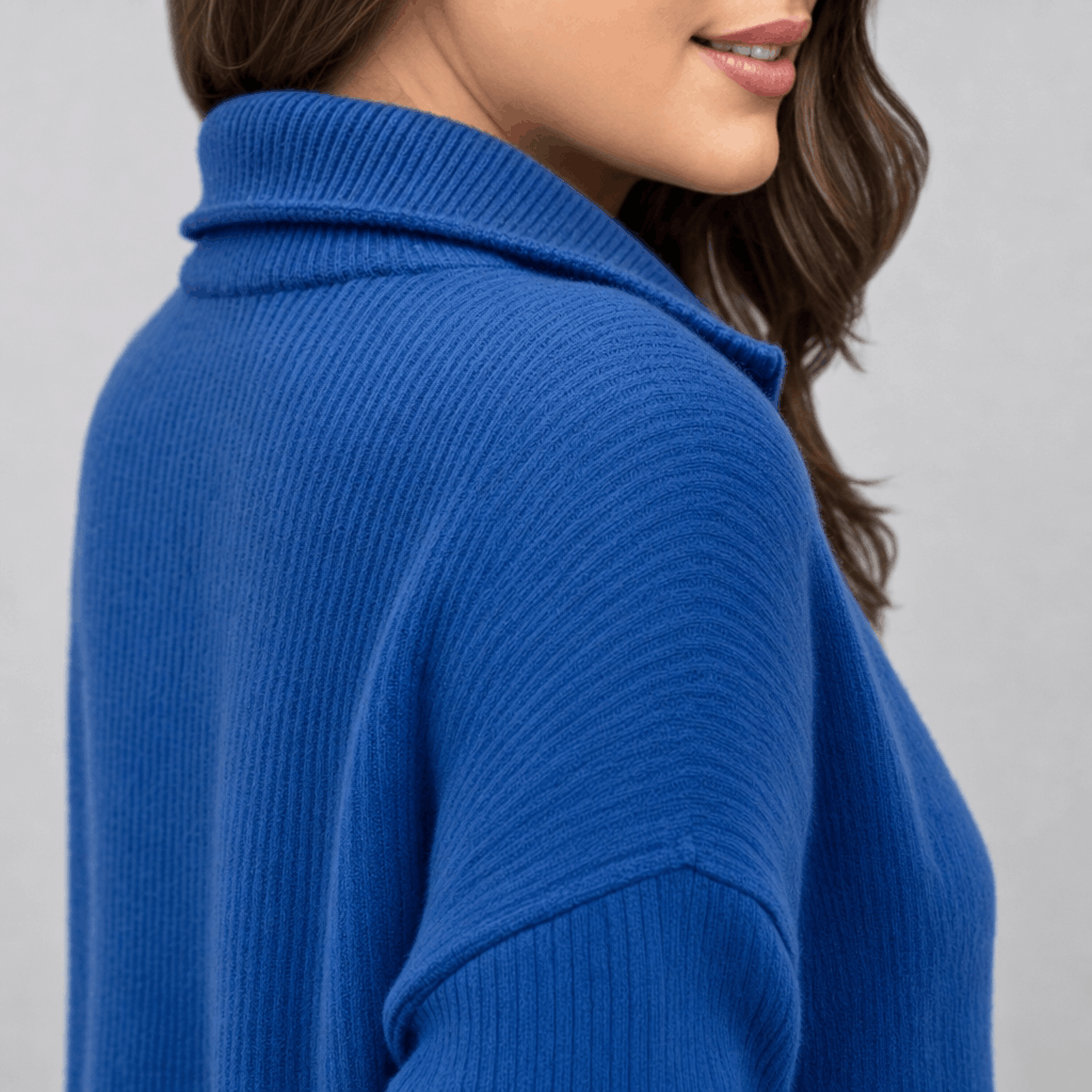 Side close-up showing the raised collar and ribbed texture of the royal blue half-zip sweater.