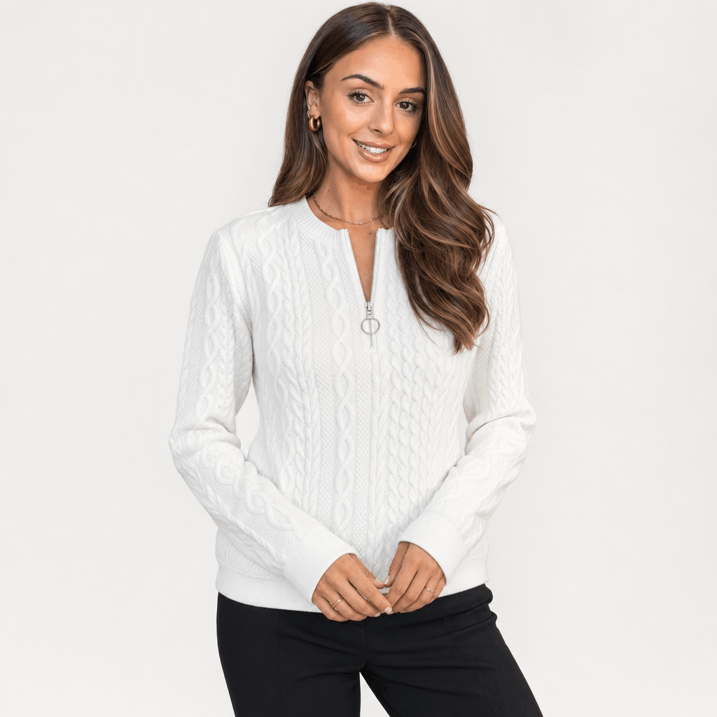 Woman wearing a light gray ribbed half-zip sweater.