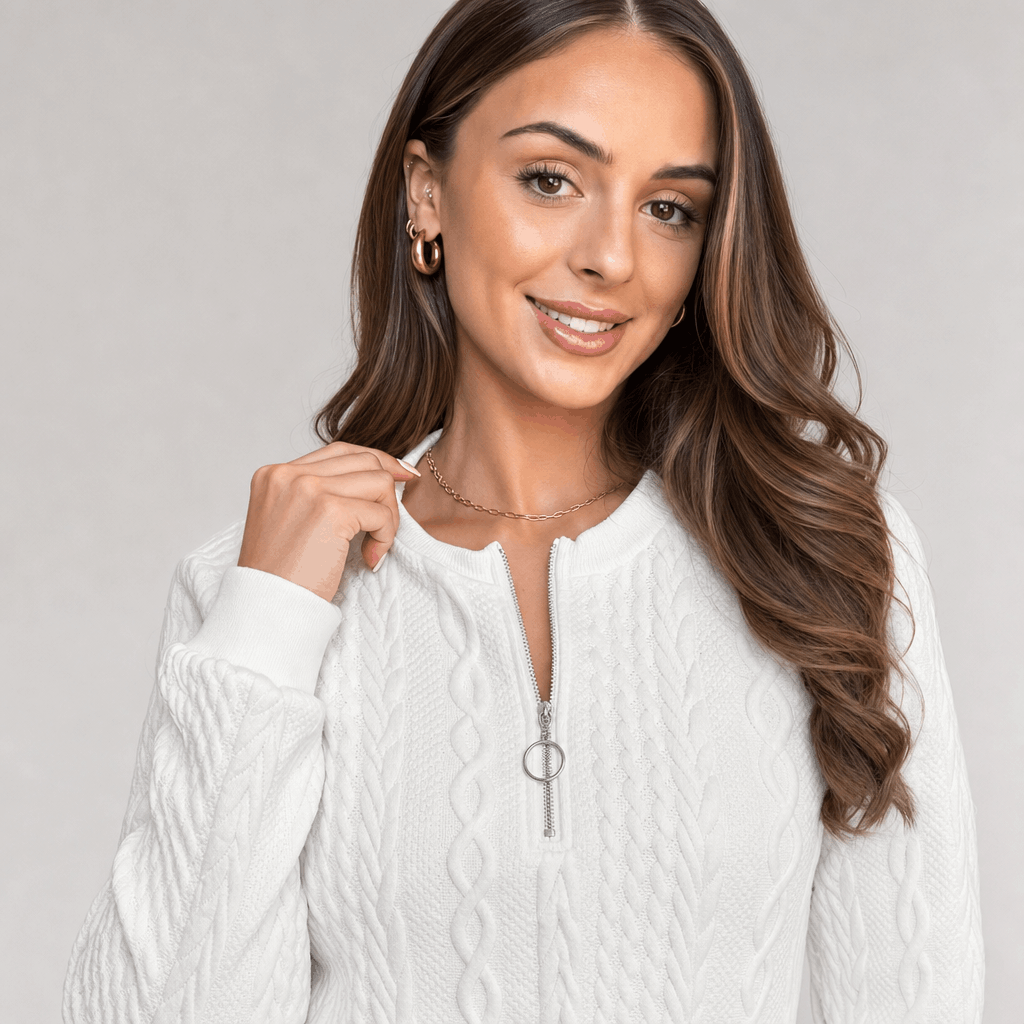 Woman wearing a light gray ribbed half-zip sweater.