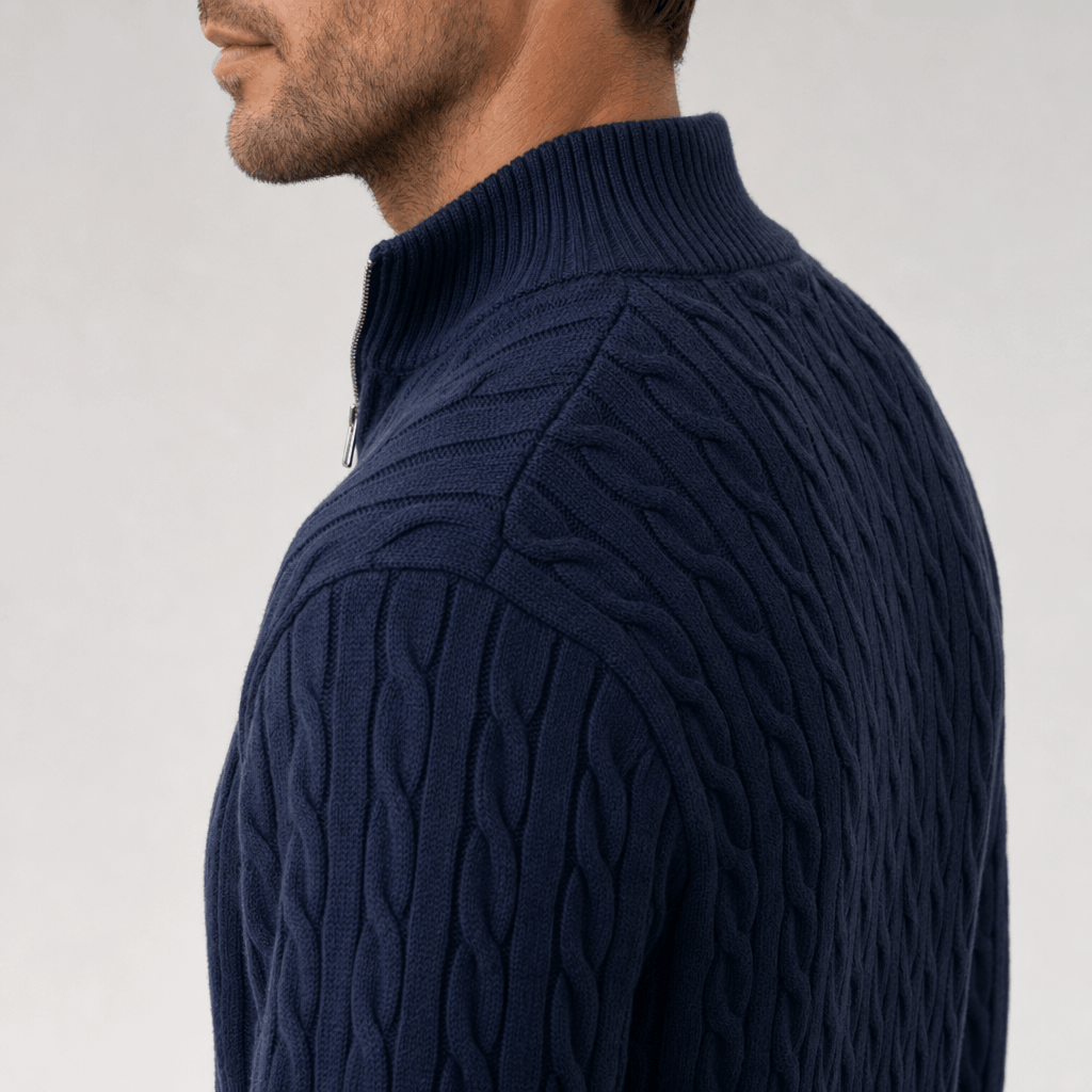 Navy blue cable knit quarter zip sweater with a structured funnel collar and ribbed trim, worn in a regular fit.