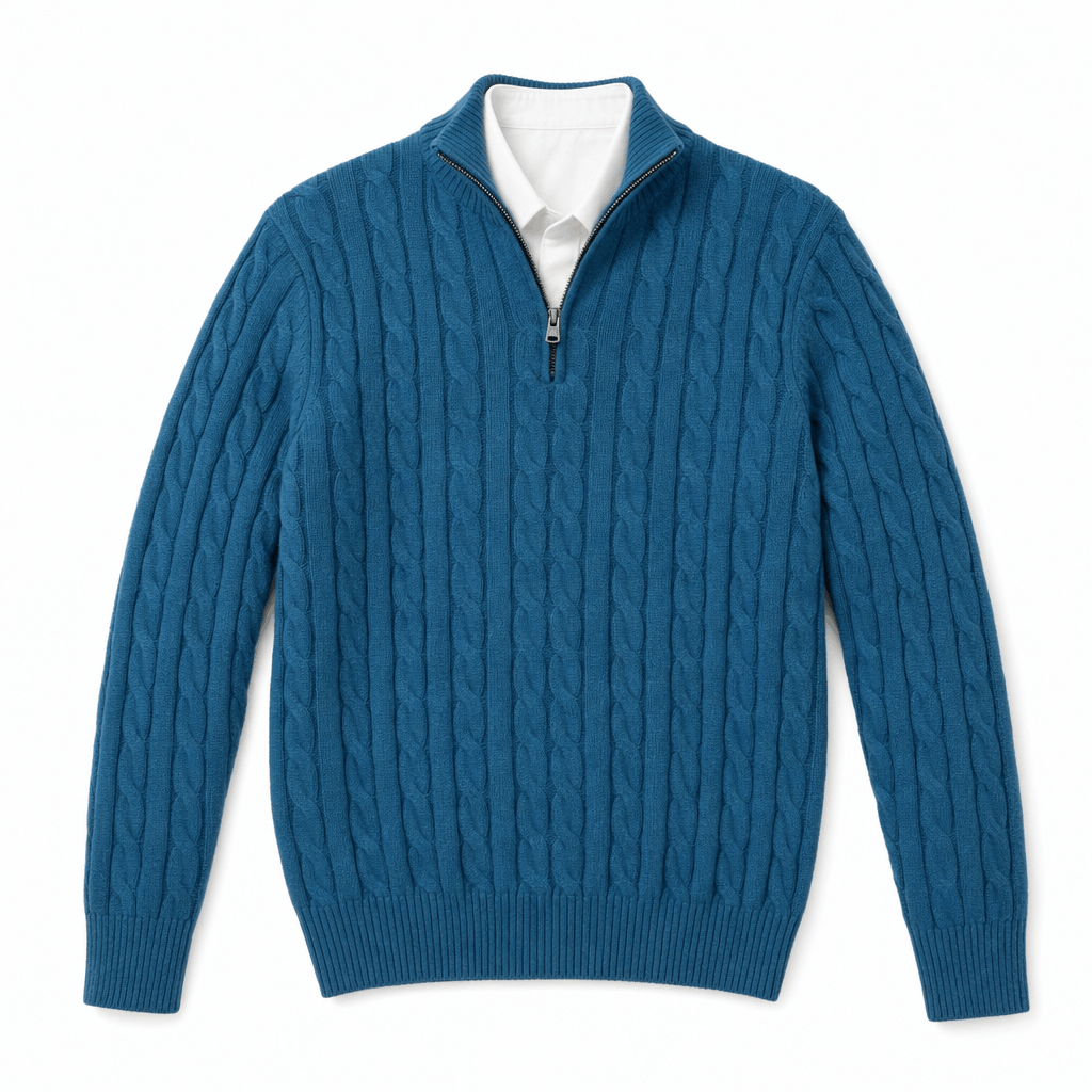 Blue cable knit quarter-zip sweater with a funnel collar, ribbed trim, and a white shirt layered underneath.