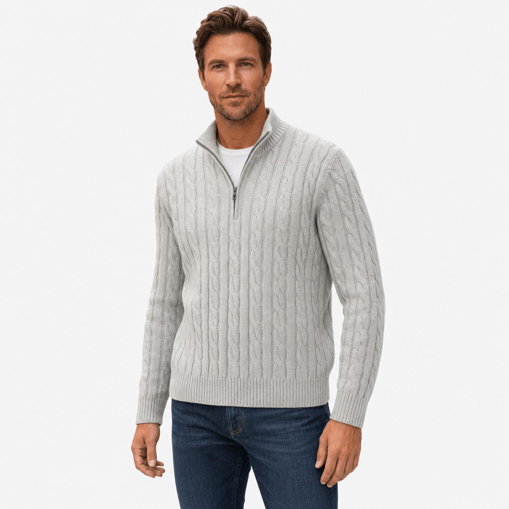 Light grey cable knit quarter-zip sweater with a funnel collar, ribbed cuffs, and hem, worn over a white t-shirt.