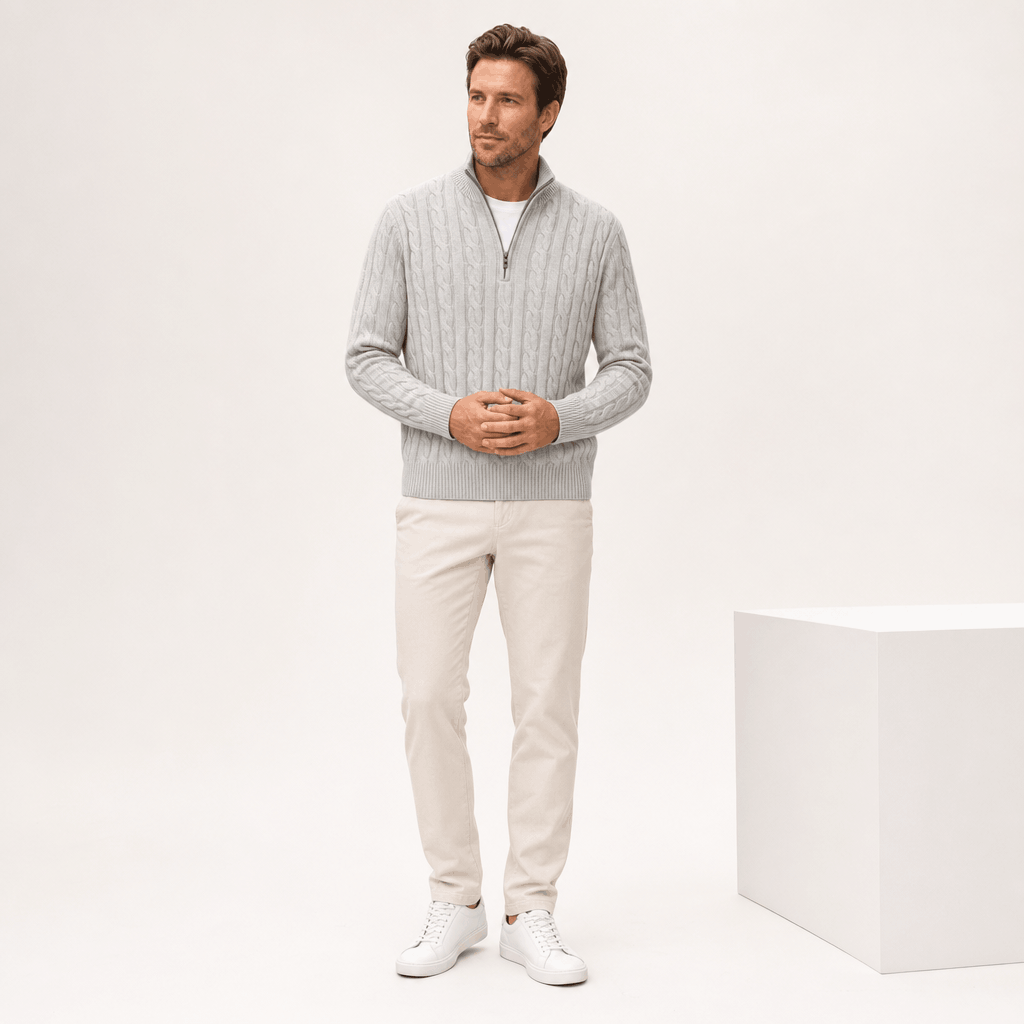 Light grey cable knit quarter-zip sweater with a funnel collar, ribbed trim, and long sleeves on a man.