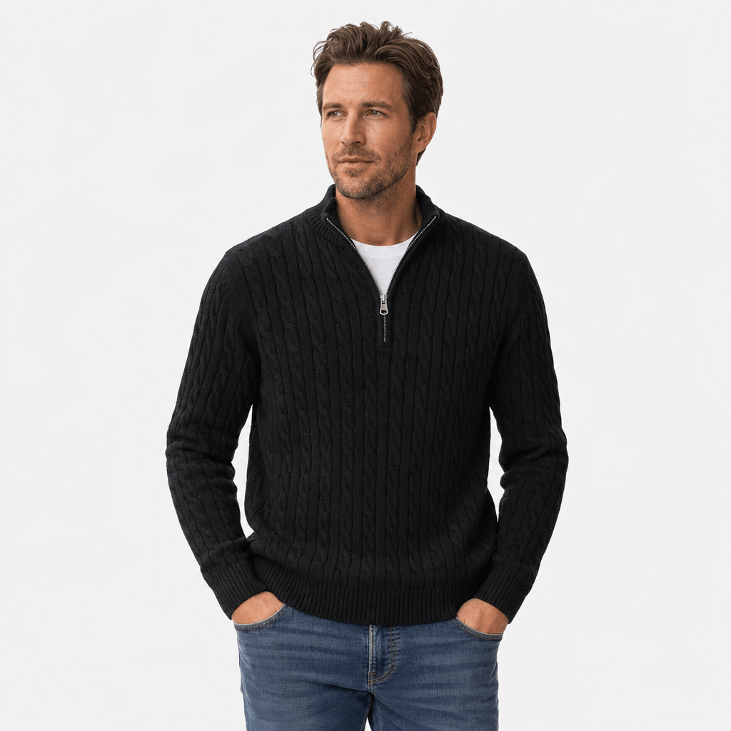 Black cable knit quarter-zip sweater with a funnel collar, ribbed cuffs, and hem, worn over a white t-shirt.
