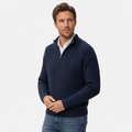 Navy blue cable knit quarter zip sweater with a funnel collar, ribbed cuffs, and hem worn over a white collared shirt.