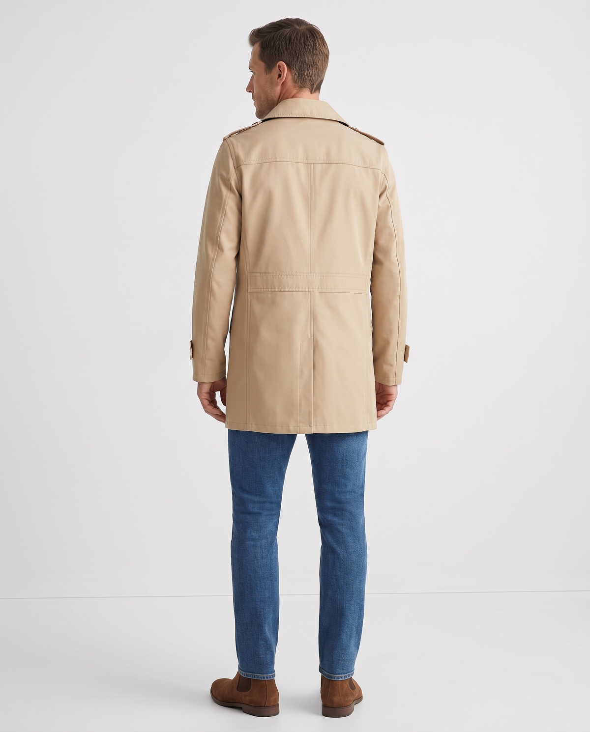 A man wearing a beige single-breasted trench coat with a mid-length fit and tailored silhouette, back view
